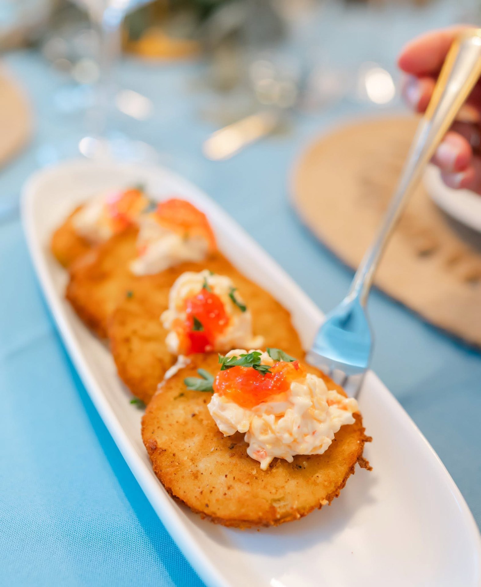 Fried green tomatoes topped with pimento cheese and pepper jelly