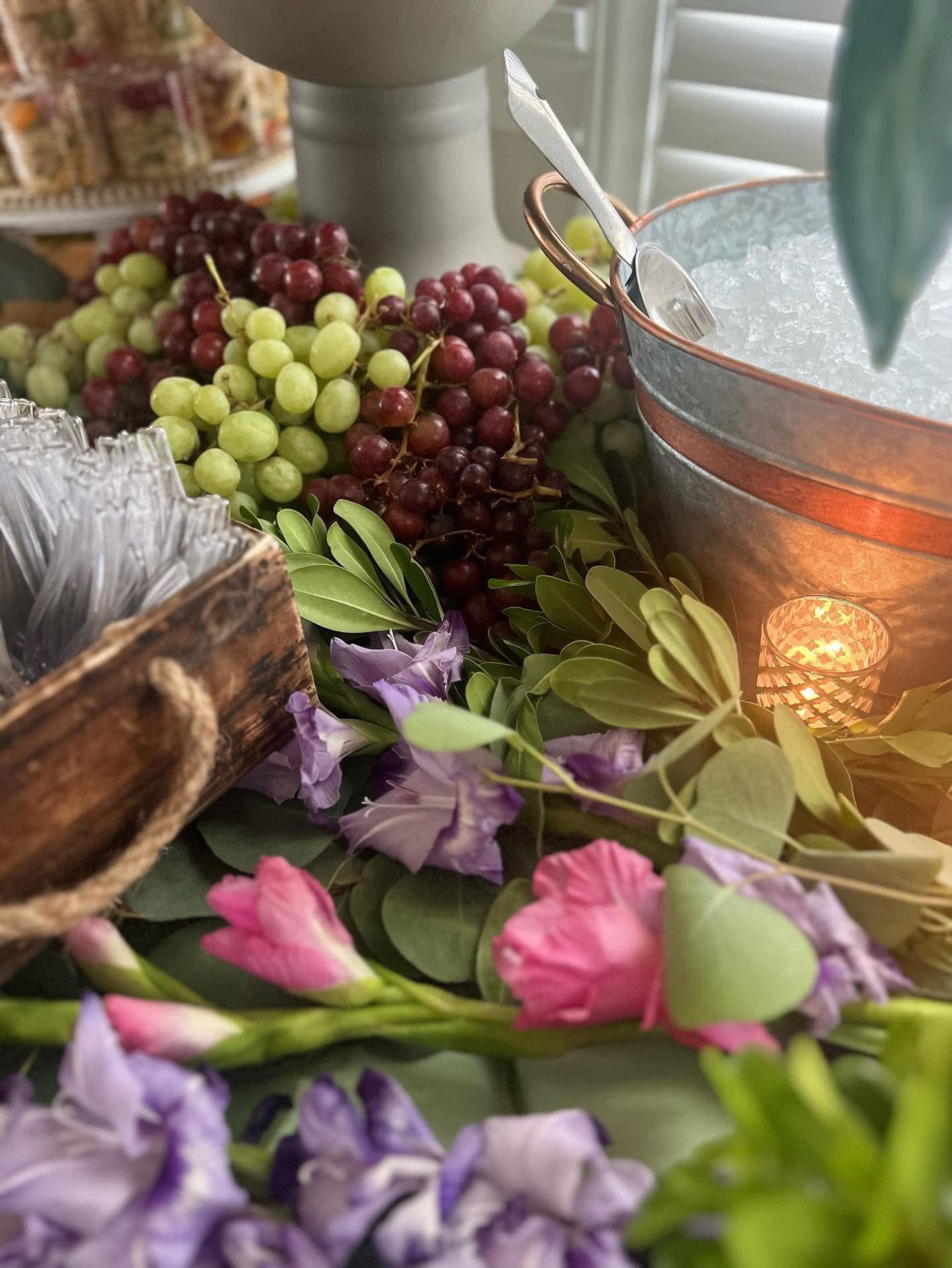 Copper drink tub framed by fresh grapes and florals