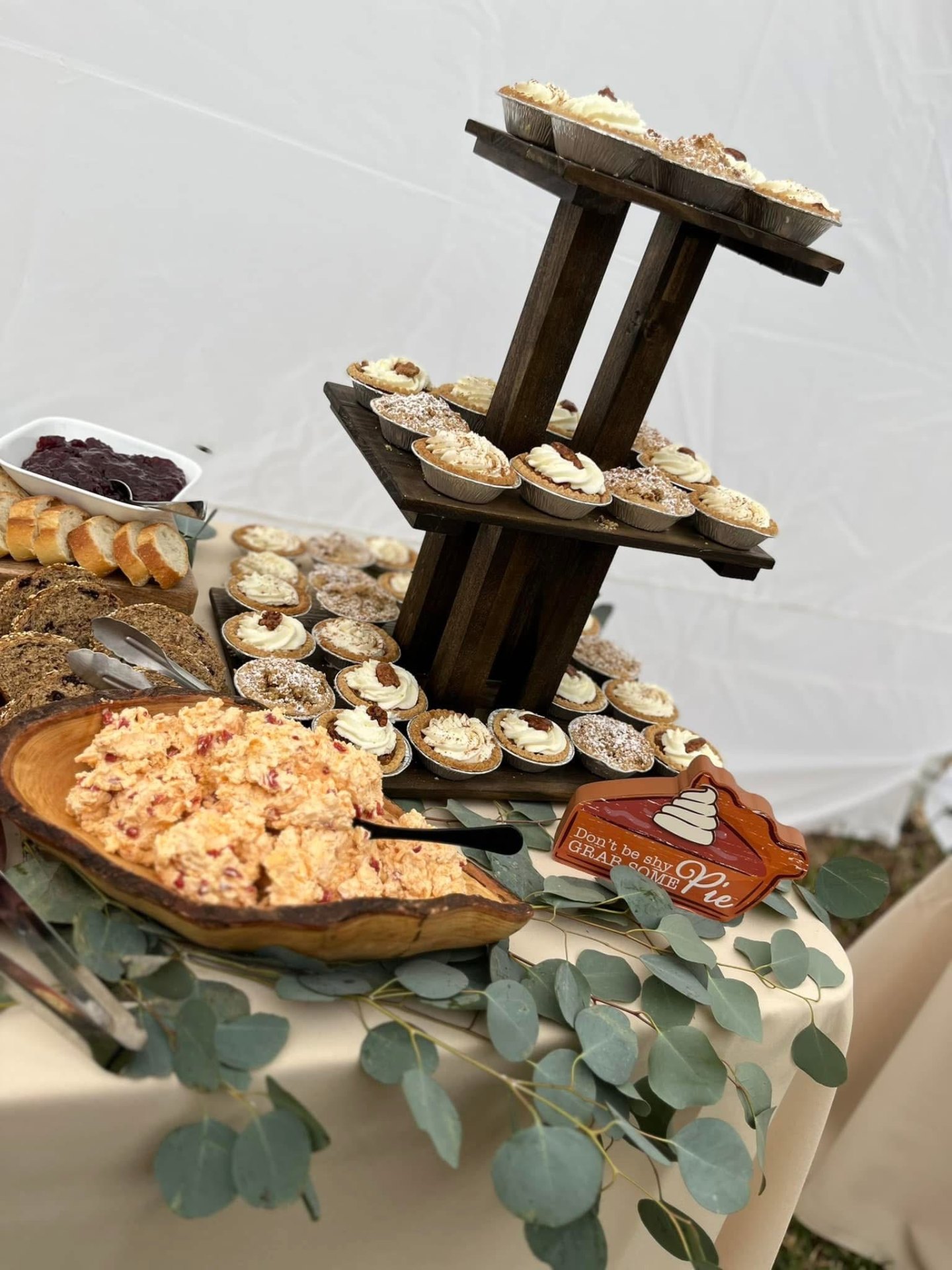 Rustic dessert table with mini pies, pimento cheese and tiered stand