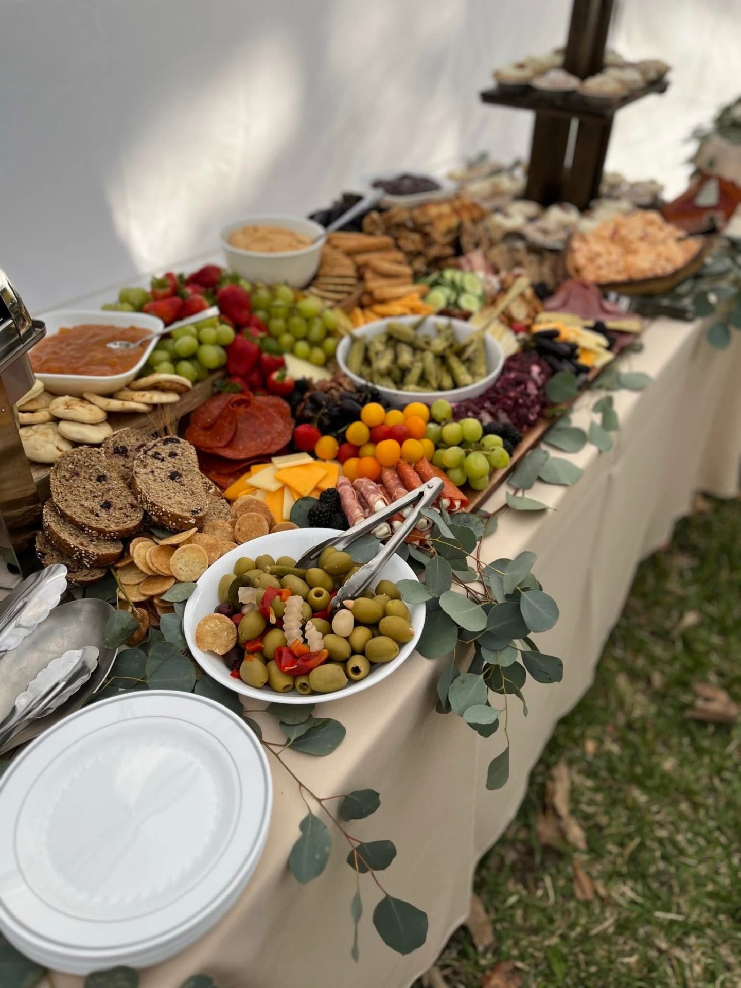 Lavish grazing table styled with charcuterie, fruit and florals